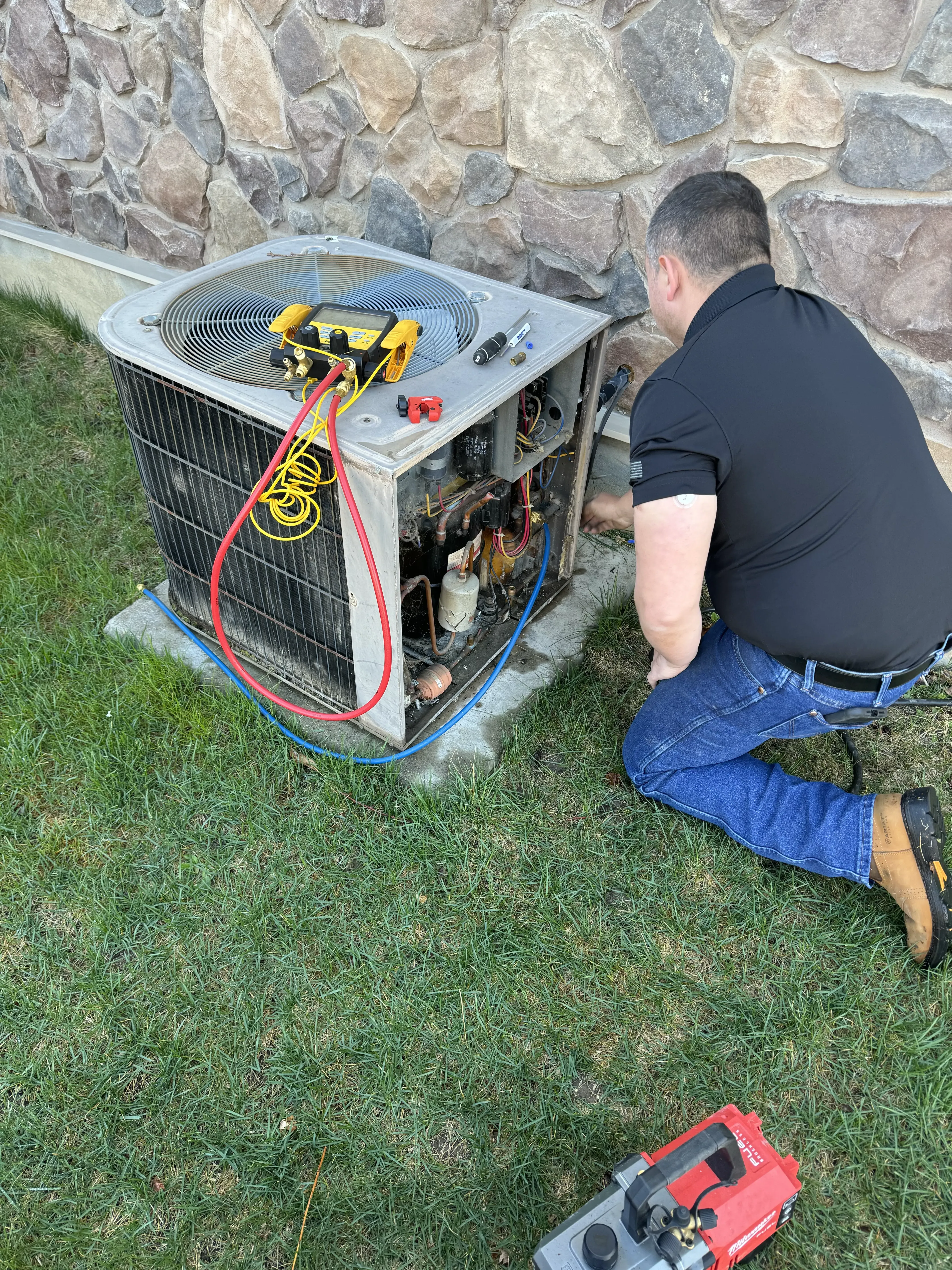 Technician servicing residential condenser unit