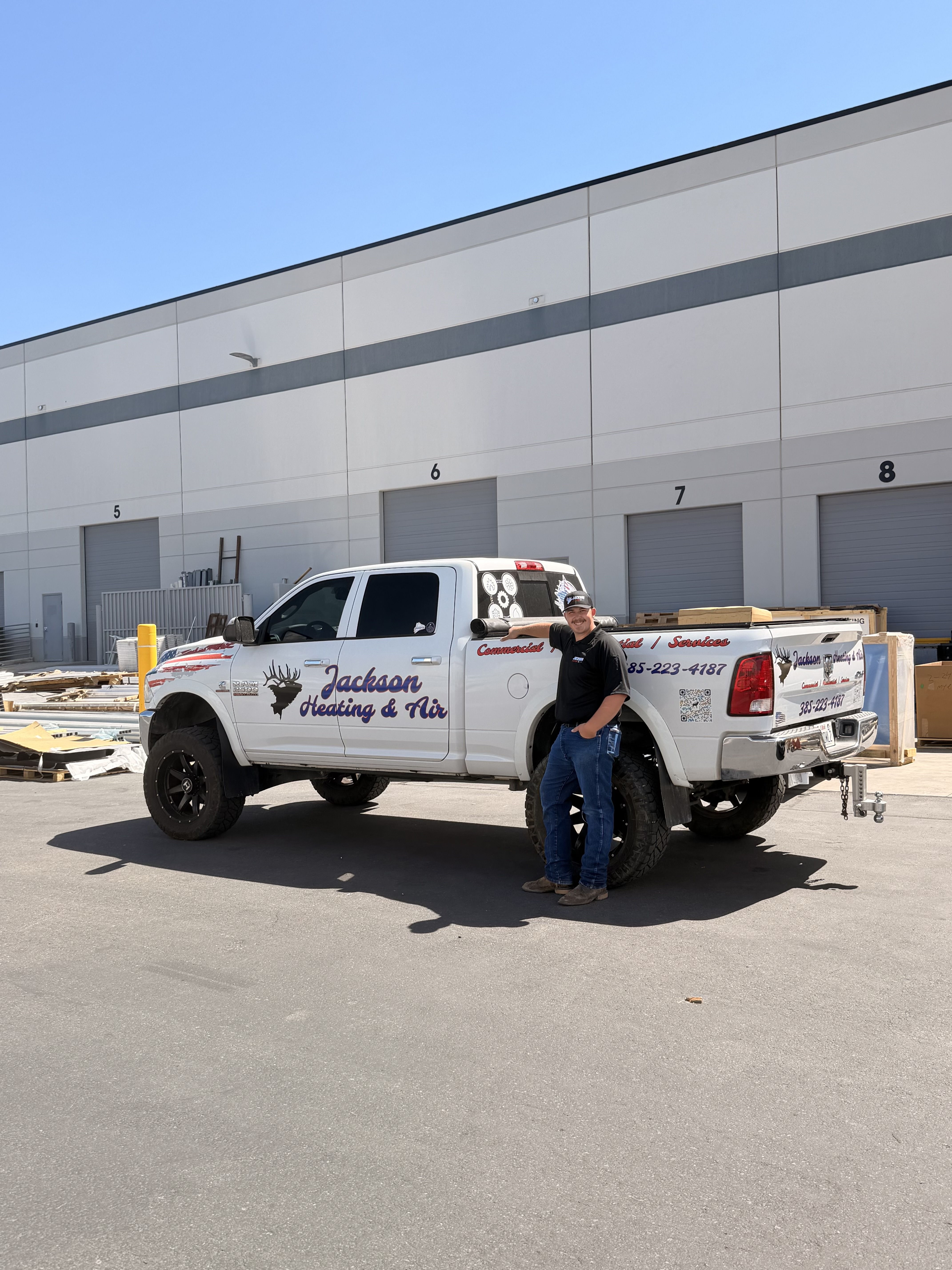 Jackson Heating & Air owner beside branded Ram service truck