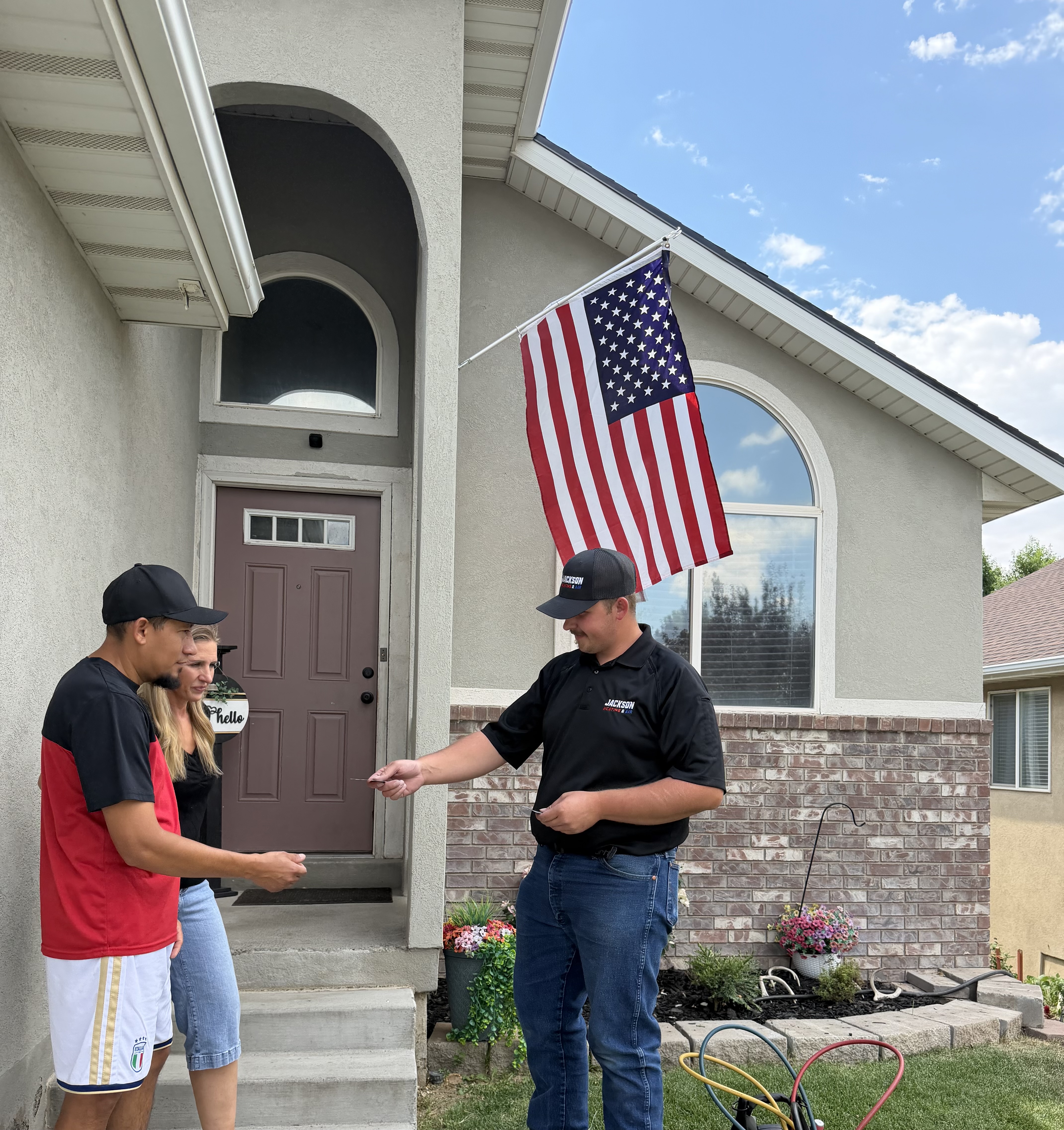 Jackson Heating & Air technician meeting with homeowners